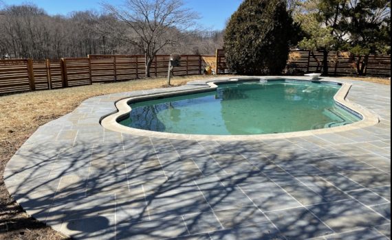Pool surrounded by a patio from landscaping and drainage solutions in Baltimore, MD