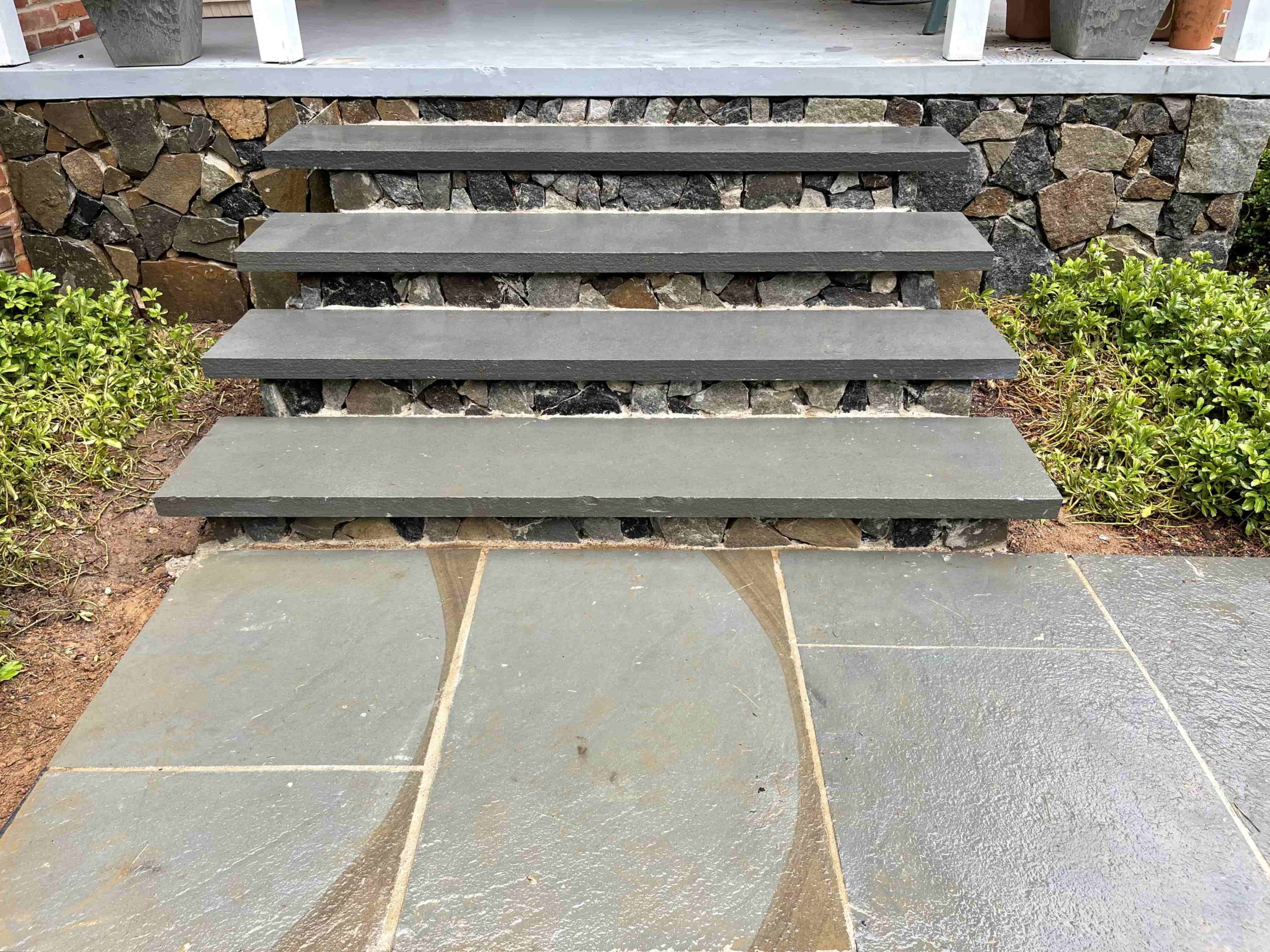 Stone patio with stairs wall by ProLandscapes in MD