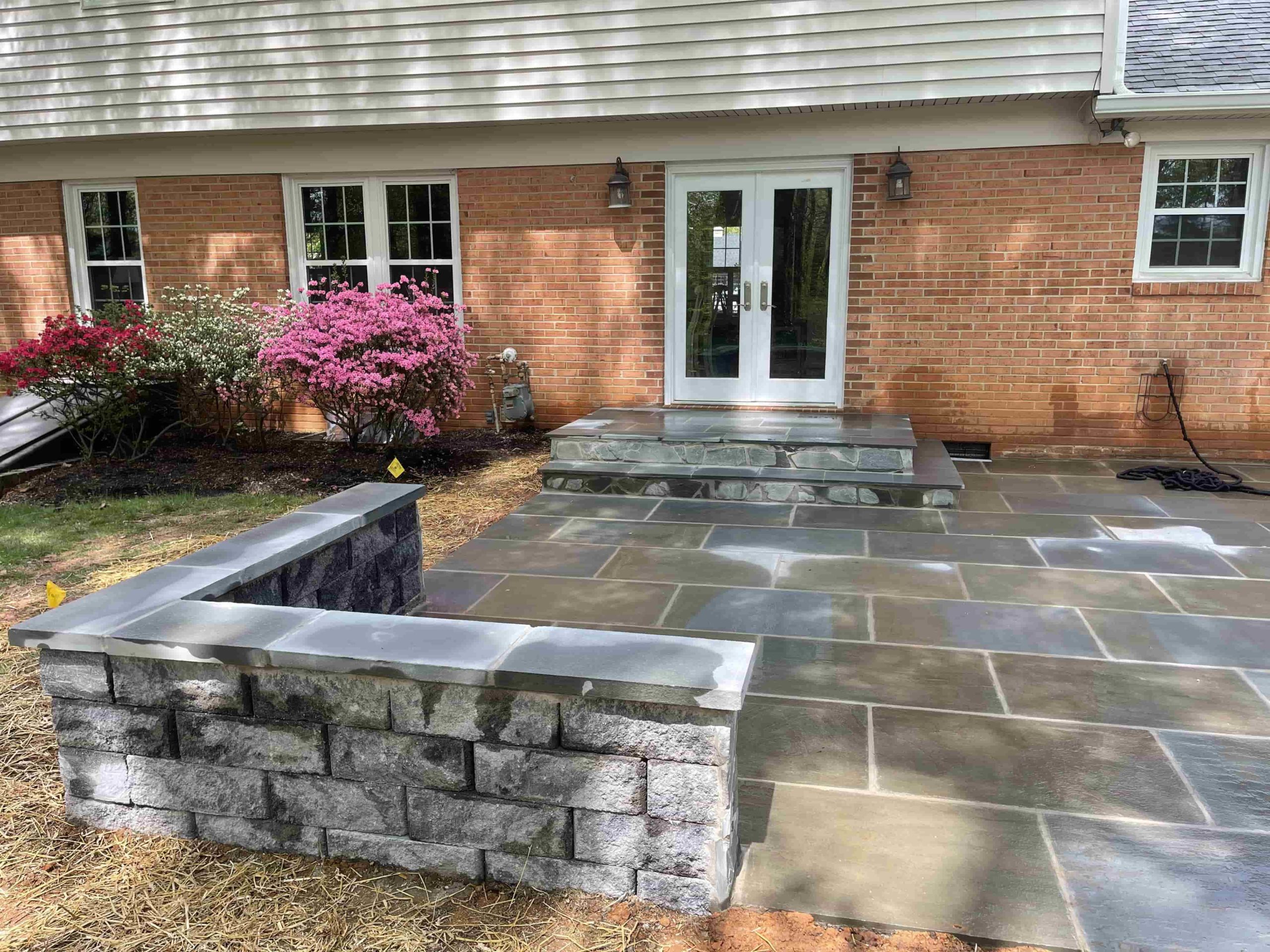 Stone patio wall by ProLandscapes in MD