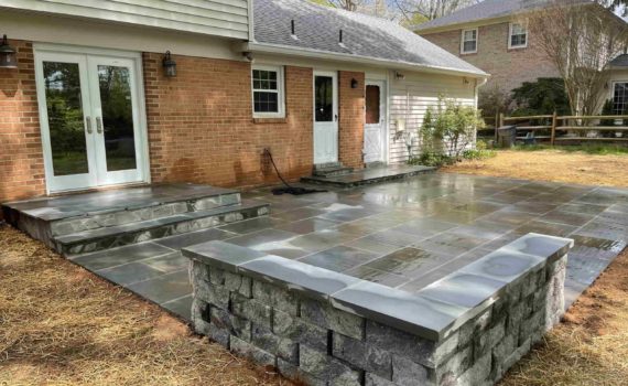 Stone patio wall by ProLandscapes in MD