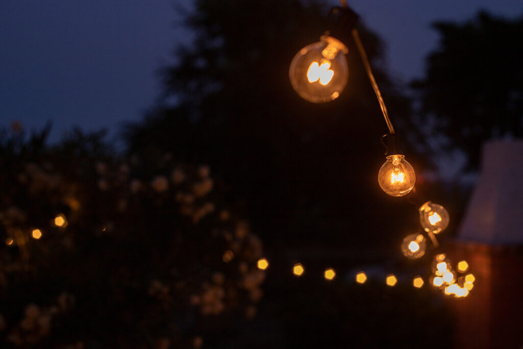 lights hanging on a terrace at night