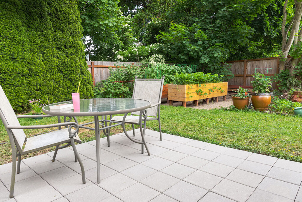 Backyard in DC with a patio and table and raised garden bed.