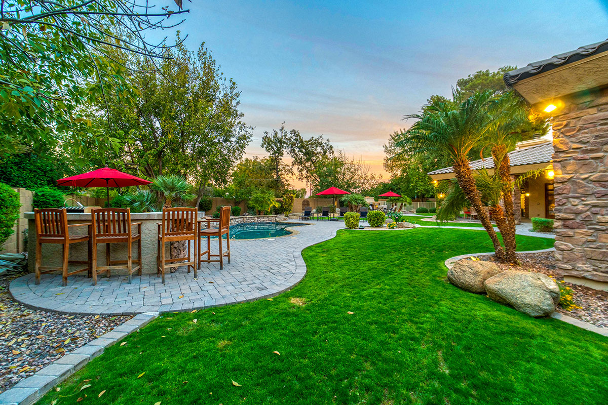 Backyard photo of a patio with table nd greenery showing an example of Landscaping and Hardscaping in Maryland and Washington DC.